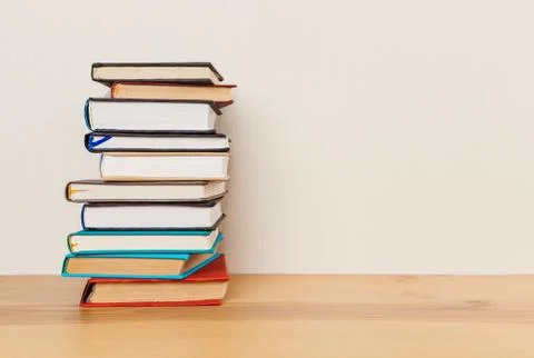 Simple composition of many hardback books, raw of books on wooden table and l Stock Photos