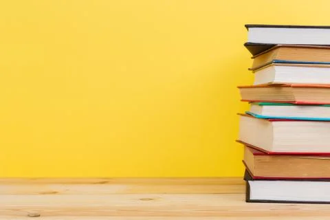 Simple composition of many hardback books, raw of books on wooden table and p Stock Photos