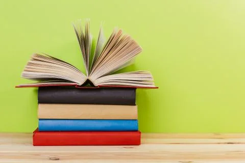Simple composition of many hardback books, raw of books on wooden table and l Stock Photos