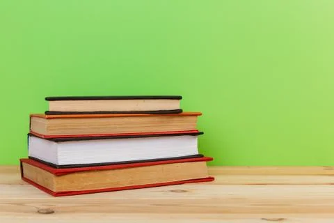 Simple composition of many hardback books, raw of books on wooden table and l Stock Photos