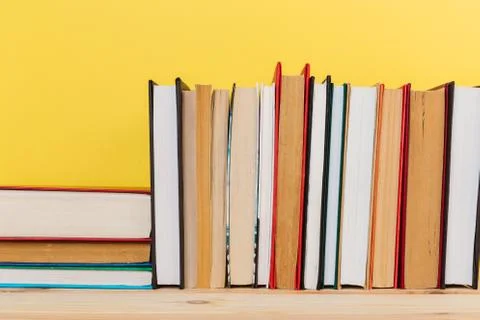 Simple composition of many hardback books, raw of books on wooden table and p Stock Photos
