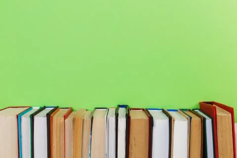 Simple composition of many hardback books, raw of books on wooden table and l Stock Photos