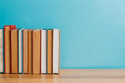 A simple composition of many hardback books, raw books on a wooden table and  Stock Photos