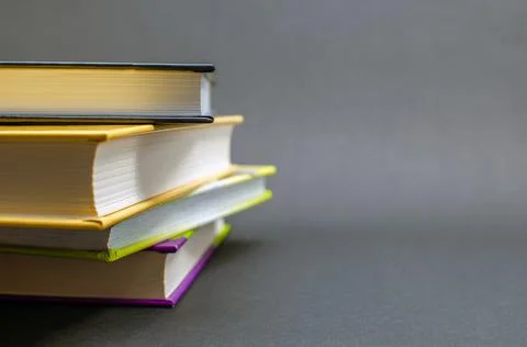 A simple composition of many hardback books on a black background. Back to Stock Photos