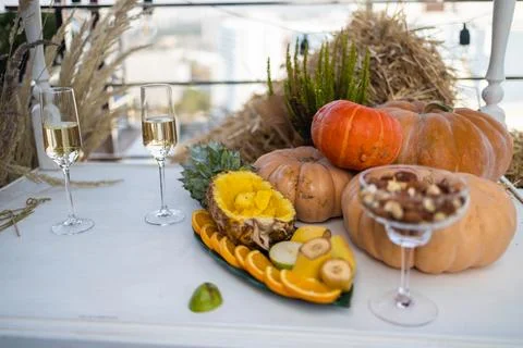 Simple craft elements, pumpkins as decoration, candles. Lunch outdoors Stock Photos