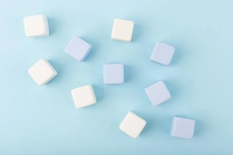Simple creative flat lay with toy cubes spilled on bright blue background with Stock Photos