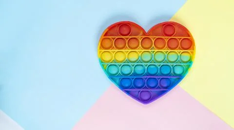 Simple dimple multi-colored sensory pop it toy Stock Photos