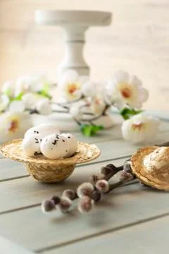Simple easter decoration with egg, hay wreath and white flowers. Stock Photos