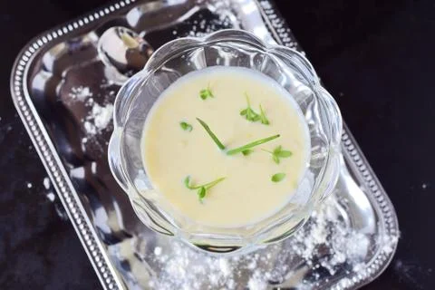 Simple easy to cook milk based gravy in a glass on a metal tray. Healthy food Stock Photos