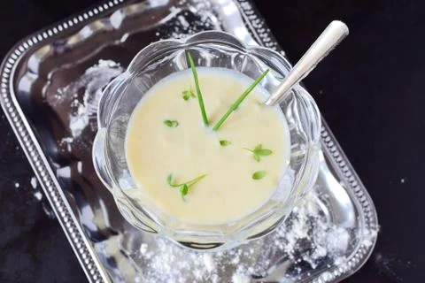 Simple easy to cook milk based gravy in a glass on a metal tray. Healthy food Stock Photos