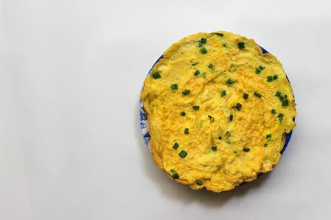 Simple egg omelette with herbs on white background Stock Photos
