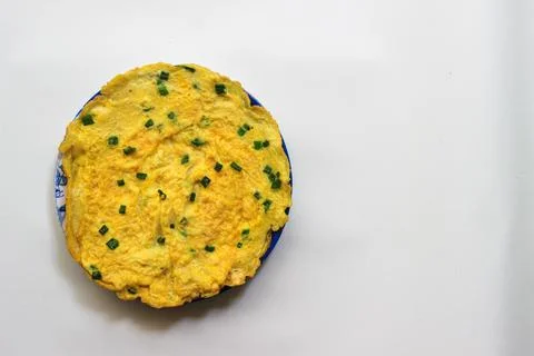 Simple egg omelette with herbs on white background Stock Photos