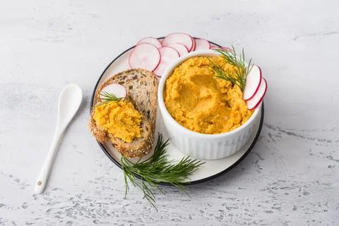 Simple egg pate or dip with carrots and fried onions in a white bowl Stock Photos