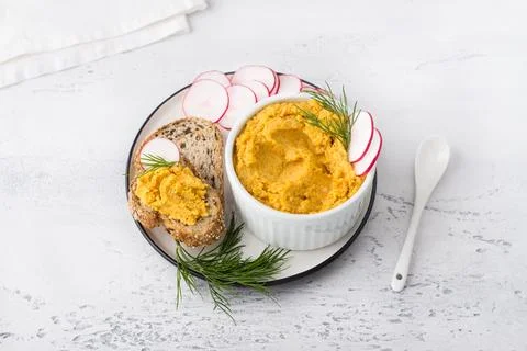 Simple egg pate or dip with carrots and fried onions in a white bowl Stock Photos
