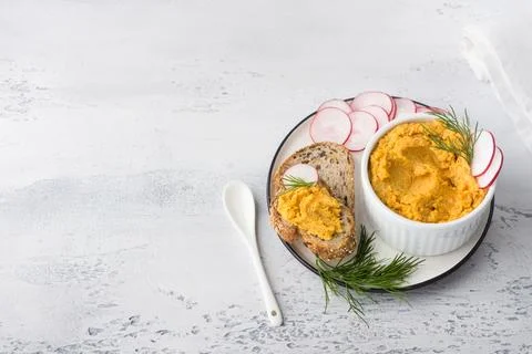 Simple egg pate or dip with carrots and fried onions in a white bowl Stock Photos