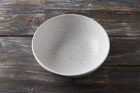 Simple empty light gray ceramic bowl on wooden table, rustic style, top view Stock Photos