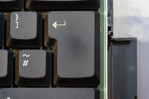 Simple enter key on a laptop computer keyboard seen from above, object deta.. Stock Photos