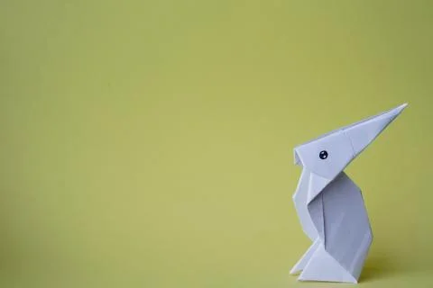 Simple flat lay out. White rabbit paper origami on clear background with copy Stock Photos