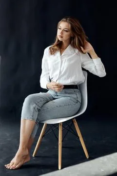 Simple girl on a solid dark background Stock Photos