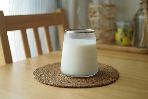 Simple glass of milk on a table Stock Photos