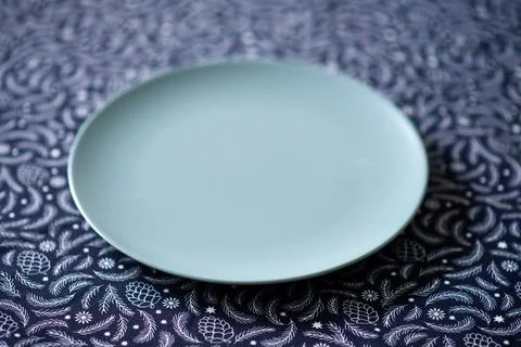 Simple gray plate on patterned background 스톡 사진