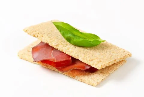 Simple ham and cheese crackers sandwich with basil Stock Photos