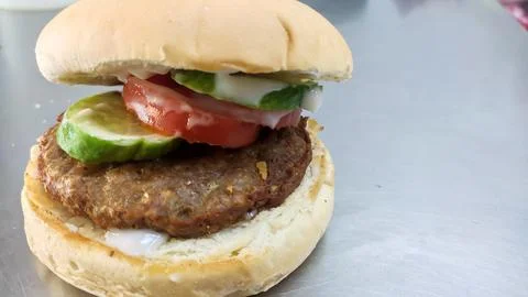 Simple hamburger placed on the table for product display. Stock Photos