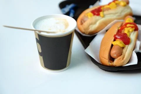 Simple hot dog sandwich breakfast with mustard ketchup and coffee. Stock-Fotos