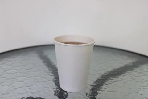 Simple Hot Tea in a White Disposable Paper Cup on a Textured Glass Table Stock Photos