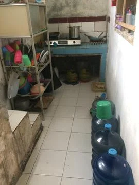 Simple Kitchen Interior with Cooking Utensils and a Water Jug 스톡 사진