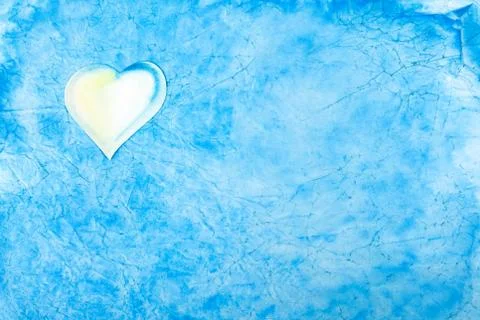 Simple light blue abstract cloud like background texture with a white heart Stock Photos