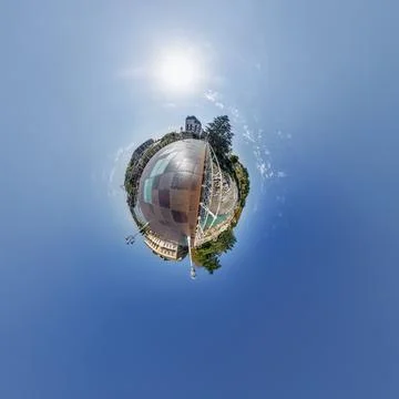 Simple little tiny planet with buildings in blue sky with sun and beautiful c Fotos de archivo