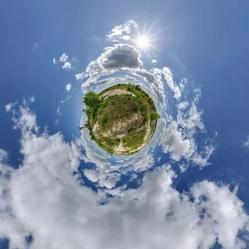 Simple little tiny planet without buildings in blue sky with sun and beautifu Stock Photos