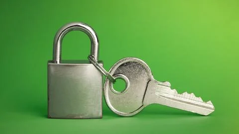 Simple lock and key. Small worn padlock with over large shiny key. Business.. Stock Photos