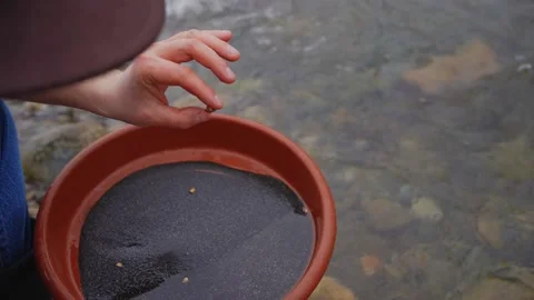 Simple manual tools plate in the hands of a gold digger washing gold on the Stock Footage 233974776