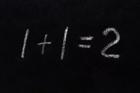 Simple math equation 1 1 2 written school board chalk. Blackboard equations one Stock Photos