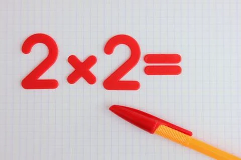 A simple mathematical example in a clean school notebook. Back to school. Stock Photos