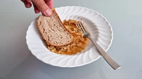 Simple Meal of Bread and Onion in Tomato Sauce on White Plate Stock Footage 337286321