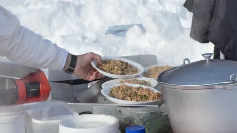 Simple meal. The cook puts on a tray plates with buckwheat porridge . Video stock 124998010