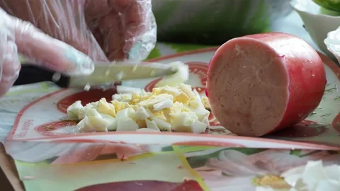 Simple meal. The cook is slicing an egg into small pieces. Stock-Footage 135163287