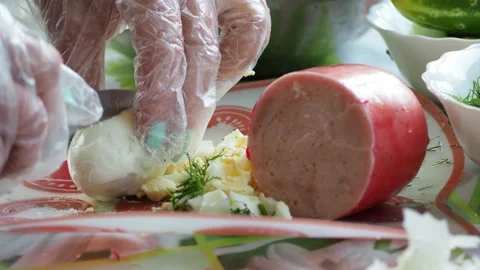 Simple meal. The cook is slicing an egg. Video stock 135163305