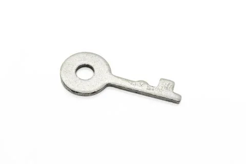 Simple metallic key on white background Stock Photos