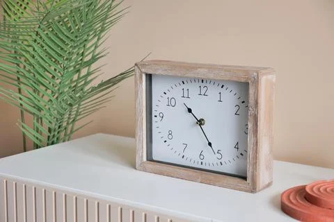 Simple modern clock on table Stock Photos