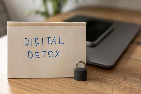 Simple note for digital detox placed on a wooden table with a locked phone Stock Photos