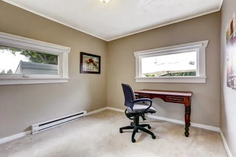 Simple office interior with desk and chair Stock Photos