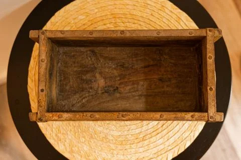 Simple open wooden box without lid on plain surface Stock Photos