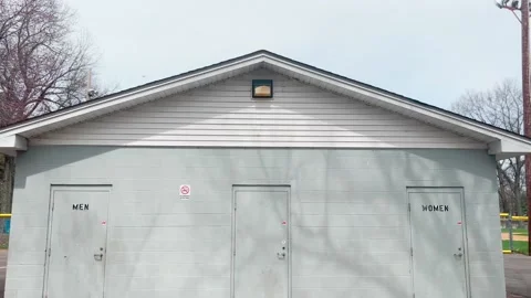 SIMPLE PAN DOWN SHOT OF PLAYGROUND RESTROOM FRONT Stock Footage 182480634
