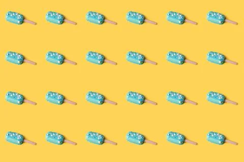 Simple pattern blue mint ice cream popsicles on yellow background. Tasty and  Stock Photos