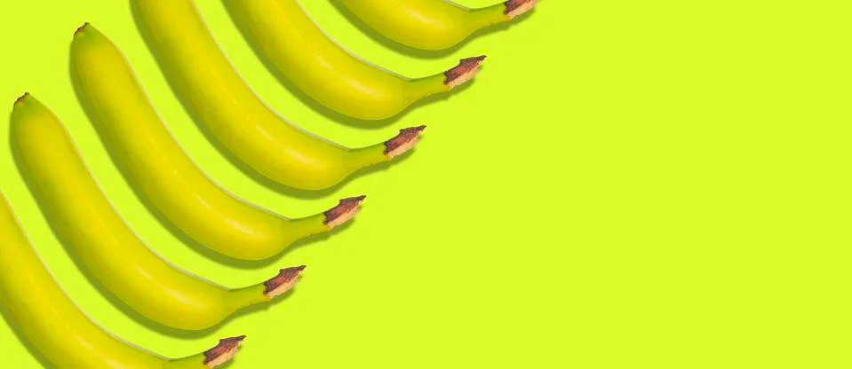 Simple pattern with clean bananas isolated on colorful background Stock Photos