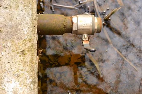 Simple photo background composition image of metall valve in the swamped pond Stock Photos